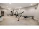 Spacious carpeted basement with home gym and weight-lifting equipment and window light at 6963 E Heritage S Pl, Centennial, CO 80111
