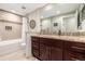 Bathroom with granite countertop and vanity, a bathtub, and a decorative mirror at 6963 E Heritage S Pl, Centennial, CO 80111