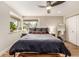 Bedroom features hardwood floors, a ceiling fan, and natural light from the windows at 6963 E Heritage S Pl, Centennial, CO 80111