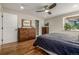 Comfortable bedroom with hardwood floors, natural light, and a neutral color palette at 6963 E Heritage S Pl, Centennial, CO 80111