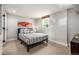 Bedroom with a gray-striped bed, small window, and a colorful painting on the wall at 6963 E Heritage S Pl, Centennial, CO 80111
