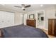 Bedroom with wood floors, a large dresser, and an ensuite bathroom entrance at 6963 E Heritage S Pl, Centennial, CO 80111