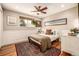 Bedroom with wood floors, a large window, and cozy decor at 6963 E Heritage S Pl, Centennial, CO 80111