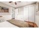 Bedroom with wood floors, closet, and access to an ensuite bathroom at 6963 E Heritage S Pl, Centennial, CO 80111