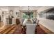 Bright dining area with hardwood floors, a large table, and a view to the kitchen at 6963 E Heritage S Pl, Centennial, CO 80111