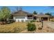 Charming home with a well-manicured front yard, featuring a stone landscape and a two-car garage at 6963 E Heritage S Pl, Centennial, CO 80111