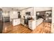 Modern kitchen with white cabinets, stainless steel appliances, granite countertops, and hardwood floors at 6963 E Heritage S Pl, Centennial, CO 80111