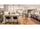 Modern kitchen with granite countertops, white cabinetry, stainless steel appliances, and hardwood floors at 6963 E Heritage S Pl, Centennial, CO 80111
