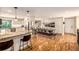 Bright kitchen featuring granite countertops, stainless appliances, and open dining and living spaces at 6963 E Heritage S Pl, Centennial, CO 80111