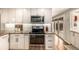 Updated kitchen featuring granite countertops, stainless steel appliances, and ample cabinet space at 6963 E Heritage S Pl, Centennial, CO 80111