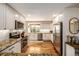 Bright kitchen with stainless steel appliances, white cabinets, granite countertops, and hardwood floors at 6963 E Heritage S Pl, Centennial, CO 80111