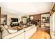 Bright living room with hardwood floors, brick fireplace, and comfortable seating at 6963 E Heritage S Pl, Centennial, CO 80111