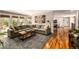 Spacious living room with hardwood floors, brick fireplace, and a large sectional sofa at 6963 E Heritage S Pl, Centennial, CO 80111