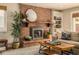 Inviting living room with brick fireplace, hardwood floors, and comfortable seating at 6963 E Heritage S Pl, Centennial, CO 80111