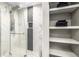 Walk-in shower with tiled walls and shelves for storage at 6963 E Heritage S Pl, Centennial, CO 80111