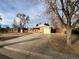 Ranch style home with a spacious driveway and mature trees at 12549 E 31St Ave, Aurora, CO 80011