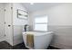 Modern bathroom featuring a sleek standalone tub with modern fixtures and tiling at 1835 S Poplar St, Denver, CO 80224