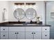 Bathroom featuring a vanity with double sinks, round mirrors, and modern lighting fixtures at 1835 S Poplar St, Denver, CO 80224