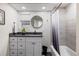 Bathroom featuring a vanity with storage, a shower with a curtain and black and white floor tiles at 1835 S Poplar St, Denver, CO 80224