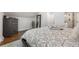 Bedroom with a gray bed, neutral bedding, wood floors, and an accent dresser at 1835 S Poplar St, Denver, CO 80224