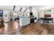 Open concept kitchen featuring stainless appliances, a central island, and hardwood flooring at 1835 S Poplar St, Denver, CO 80224