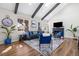 Inviting living room with dark wood beams, large windows, a cozy fireplace, and stylish, modern decor at 1835 S Poplar St, Denver, CO 80224