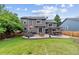 Large backyard with a lush lawn, patio with outdoor seating, and well-maintained landscaping at 19935 E Stanford Dr, Centennial, CO 80015