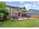Spacious backyard with a manicured lawn, patio featuring outdoor furniture, and a charming hammock at 19935 E Stanford Dr, Centennial, CO 80015