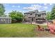 Expansive backyard with a well-maintained lawn, patio area, storage shed, and outdoor seating at 19935 E Stanford Dr, Centennial, CO 80015