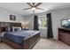 Comfortable bedroom with a ceiling fan, a window with curtains, and a queen-sized bed at 19935 E Stanford Dr, Centennial, CO 80015