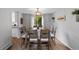 Bright dining room with a large window offering natural light, complemented by a wooden dining table and chairs at 19935 E Stanford Dr, Centennial, CO 80015