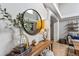 Elegant foyer table with decorative accents, a round mirror, and a stylish lamp, enhancing the home's entry at 19935 E Stanford Dr, Centennial, CO 80015