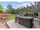 Backyard patio featuring a hot tub under a pergola with outdoor seating and landscaping at 19935 E Stanford Dr, Centennial, CO 80015