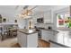 Modern kitchen features white cabinets, an island with countertop, and stainless steel appliances for a stylish and functional cooking space at 19935 E Stanford Dr, Centennial, CO 80015