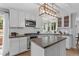 Bright kitchen features white cabinets, stainless steel appliances, and a center island, perfect for cooking and entertaining at 19935 E Stanford Dr, Centennial, CO 80015