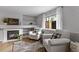 Cozy living room featuring a fireplace, built-in shelves, and comfortable armchairs, creating a warm and inviting atmosphere at 19935 E Stanford Dr, Centennial, CO 80015