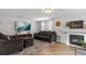 Comfortable living room features a fireplace, a large TV, and plush seating, perfect for relaxing and entertaining guests at 19935 E Stanford Dr, Centennial, CO 80015