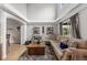Bright living room with high ceilings, a sectional sofa, decorative shelves and view into an adjacent dining room at 19935 E Stanford Dr, Centennial, CO 80015