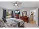 Spacious main bedroom featuring a large window and dresser with television at 19935 E Stanford Dr, Centennial, CO 80015