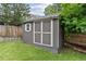 Well-maintained storage shed in the backyard with double doors and a small window at 19935 E Stanford Dr, Centennial, CO 80015