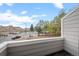 Exterior balcony view overlooking a quiet residential neighborhood with mature trees and blue sky at 4882 W 68Th Ave # 4, Westminster, CO 80030