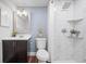 Modern bathroom with a shower, marbled tile, rain shower head, floating shelves, and decorative mirror at 4882 W 68Th Ave # 4, Westminster, CO 80030