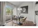 Cozy dining area with modern chandelier, hardwood floors, and sliding glass doors to balcony at 4882 W 68Th Ave # 4, Westminster, CO 80030