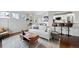 Stylish living room featuring hardwood floors, modern decor, natural lighting, and open concept to kitchen at 4882 W 68Th Ave # 4, Westminster, CO 80030