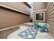 Inviting backyard patio with blue patio furniture and a decorative rug, perfect for outdoor relaxation at 1832 S Quintero Way, Aurora, CO 80017