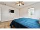 Cozy bedroom with carpet, a ceiling fan, and a modern mounted television at 1832 S Quintero Way, Aurora, CO 80017