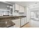 Kitchen with granite counters, white cabinets, and stainless steel appliances at 1832 S Quintero Way, Aurora, CO 80017