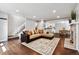 Bright living room featuring wood floors, fireplace, and stairs leading to the upper level at 1832 S Quintero Way, Aurora, CO 80017