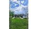 Expansive green lawn surrounded by mature trees, offering a serene outdoor space at 2846 Central Park Blvd, Denver, CO 80238