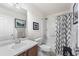 Clean bathroom with a vanity, toilet, and shower-tub combination, decorated with modern patterns at 2846 Central Park Blvd, Denver, CO 80238